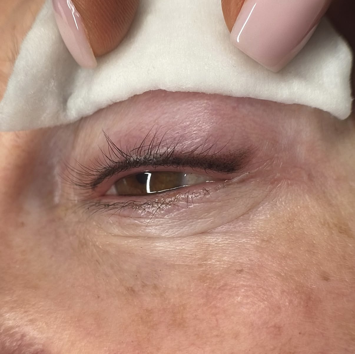 Close-up of freshly healed lash line enhancement, subtle pigment along the upper lash line for fuller-looking lashes
